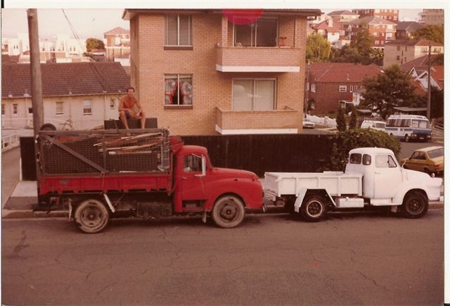 original two trucks hand loading before first bobcat