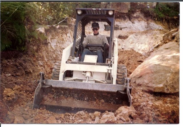 bobcat with operator digging large trench